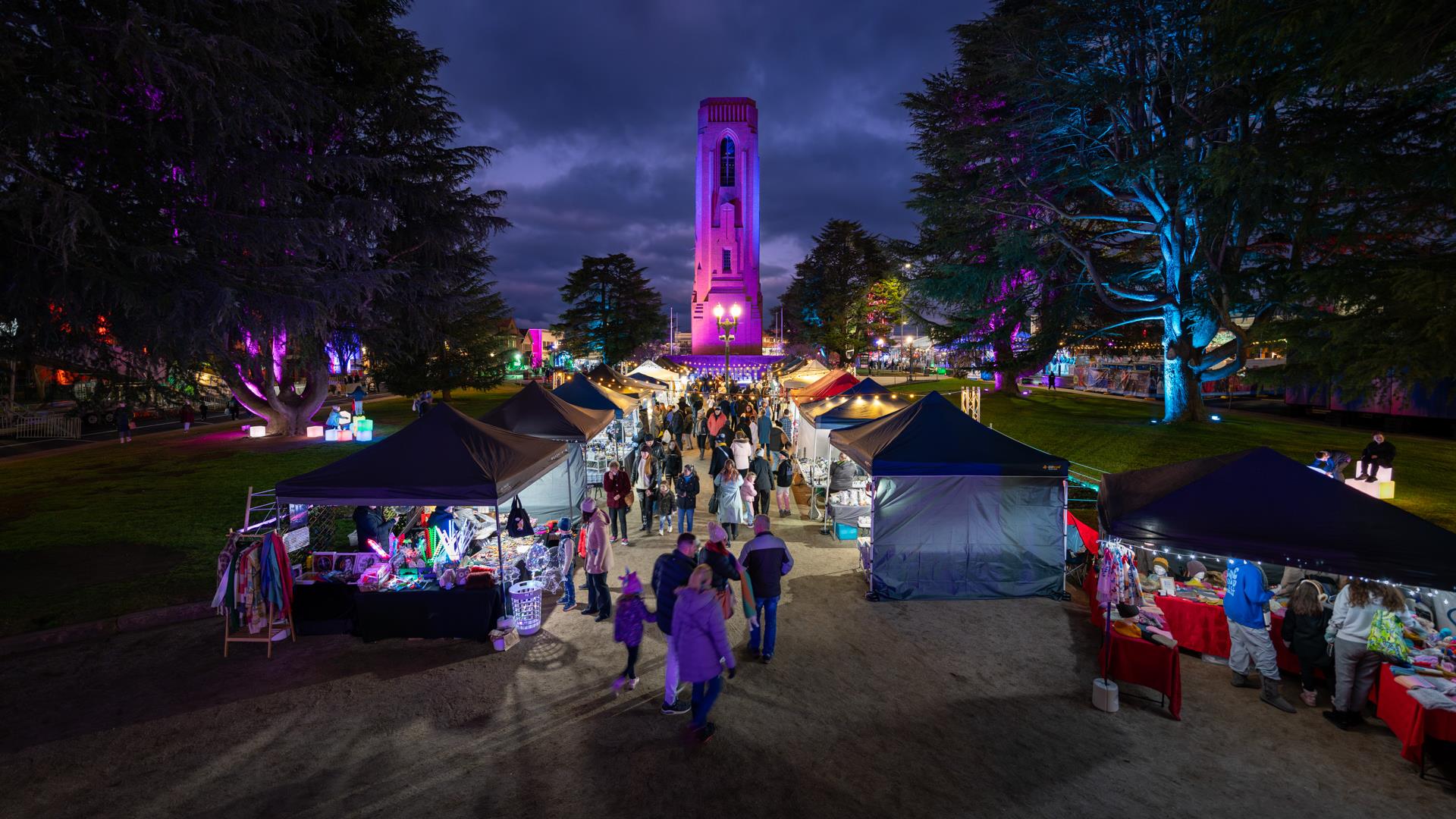 Crowds wandering the twilight markets in the park.